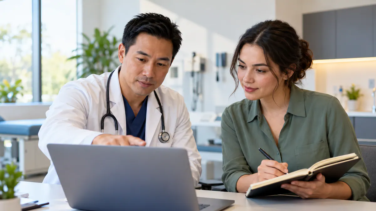 Colleagues reviewing healthcare website content: a review workflow for practitioners together at a laptop.