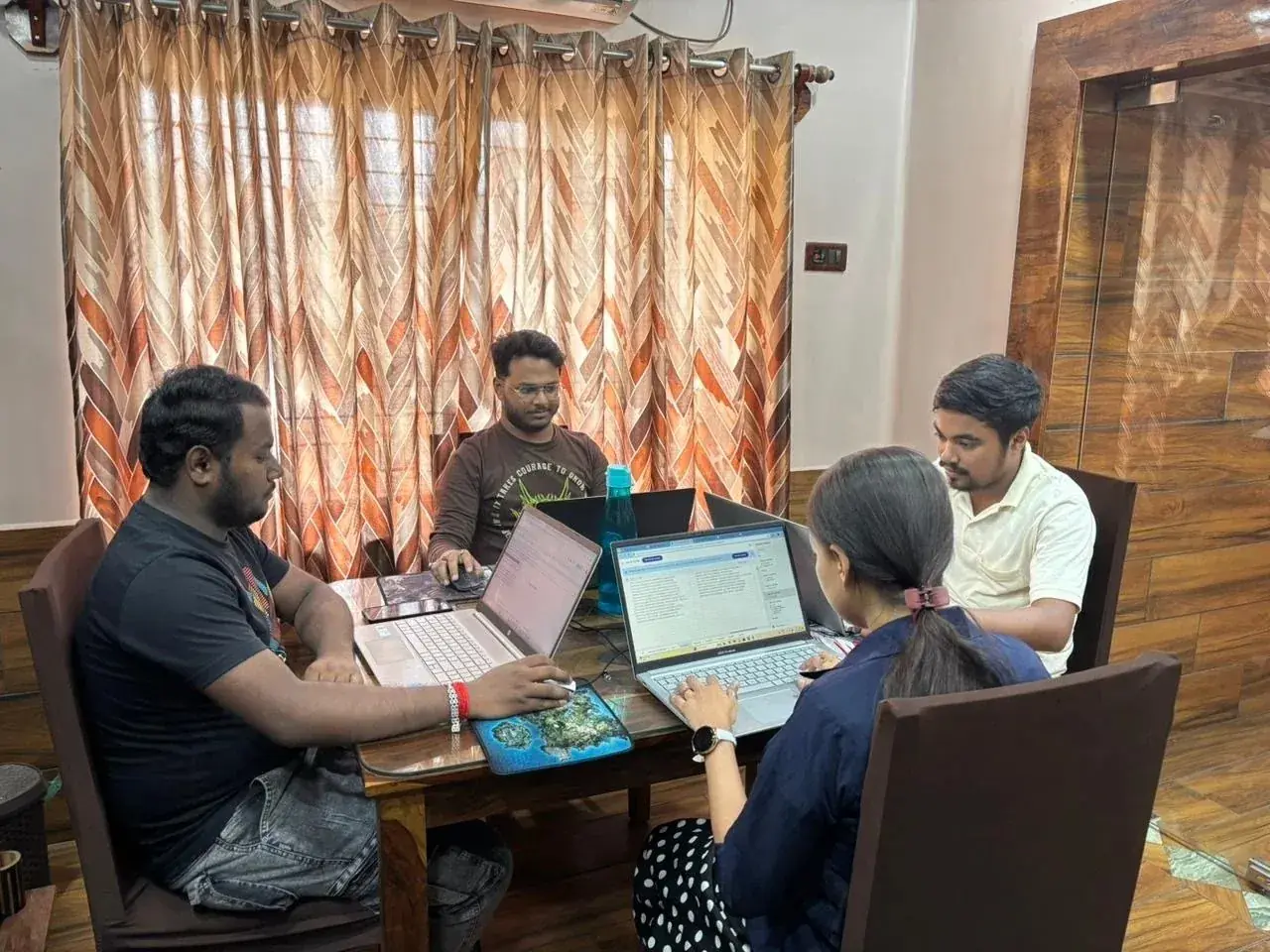 Sporteology colleagues planning a project together around a laptop